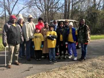 men and women, boy and girls, posing for a picture on the trail while participating in the MLK Day of Service